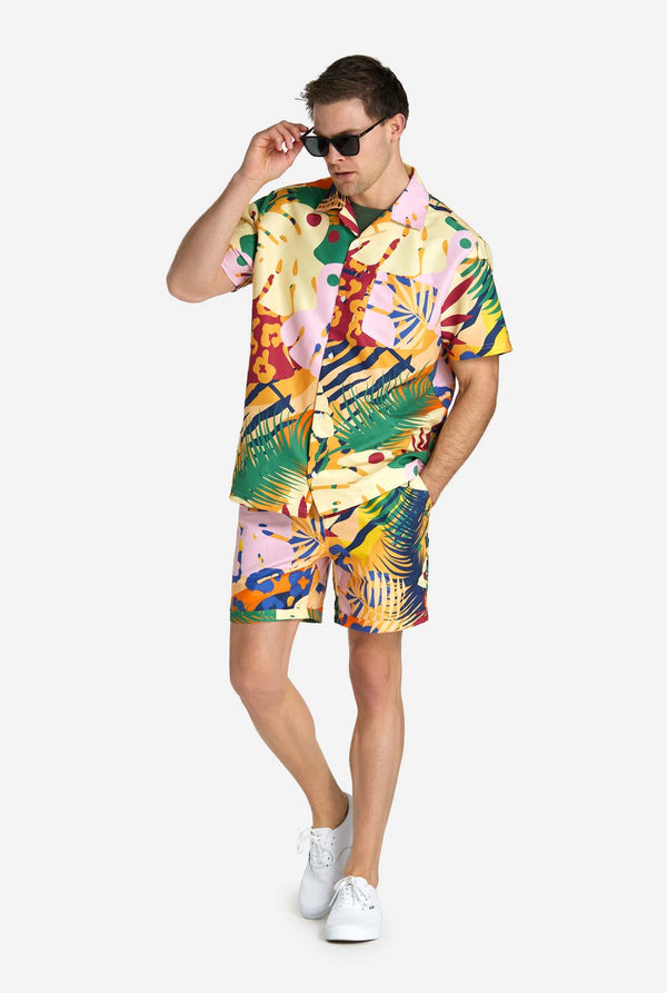 Ein Mann trägt ein tropisches Sommerset, bestehend aus einer kurzen Hose und einem Hemd mit Knöpfen