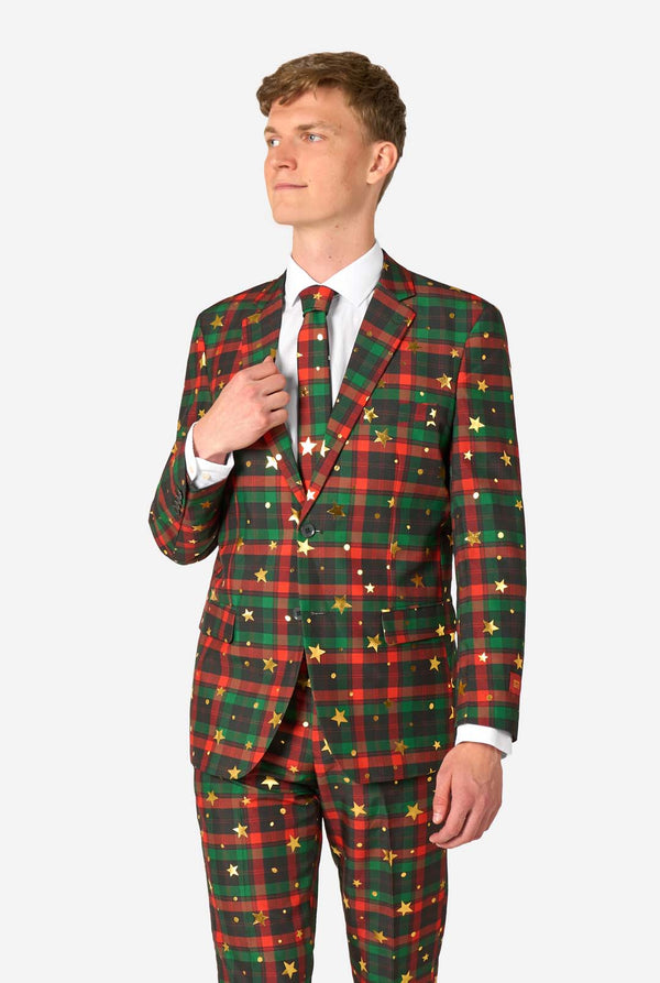 Mann im rot-grünen Tartan-Anzug mit goldenen Sternen und Punkten.