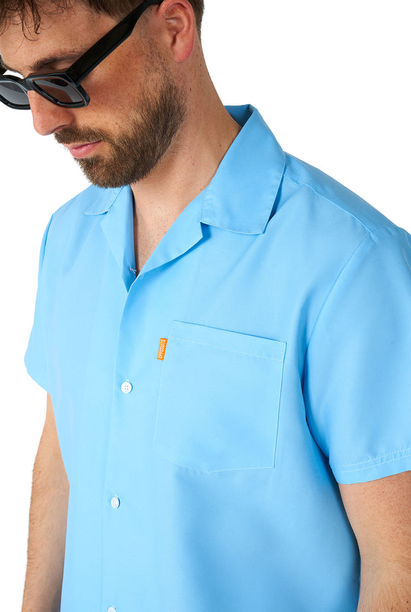 Mann trägt ein hellblaues Sommerset, bestehend aus Hemd und Shorts. Zoom auf das Hemd