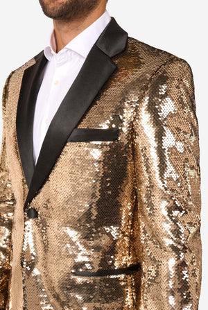 Ein Mann trägt eine glänzende, goldene Jacke mit Pailletten und schwarzen Satin-Umlegekragen.