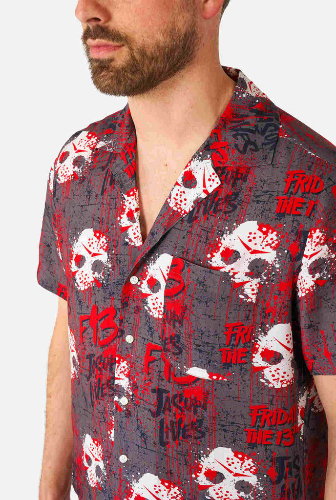 Der Mann trägt ein hawaiianisches Haloween-Hemd mit dem Aufdruck „Friday the 13th".