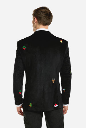 Mann trägt einen schwarzen Weihnachtsblazer mit Weihnachtsikonen