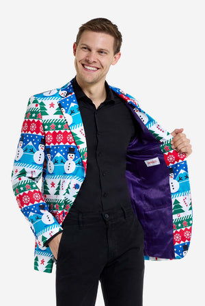 Mann trägt einen Weihnachtsblazer für Männer mit weihnachtlichen Winterfiguren. Er trägt außerdem eine schwarze Hose und ein schwarzes Herrenhemd. Die Innenseite der Jacke ist lila.