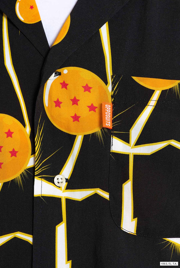 Mann trägt ein schwarzes Hawaiihemd mit Dragon Ball Z-Aufdruck, auf dem Dragon Balls und Lichter zu sehen sind. 