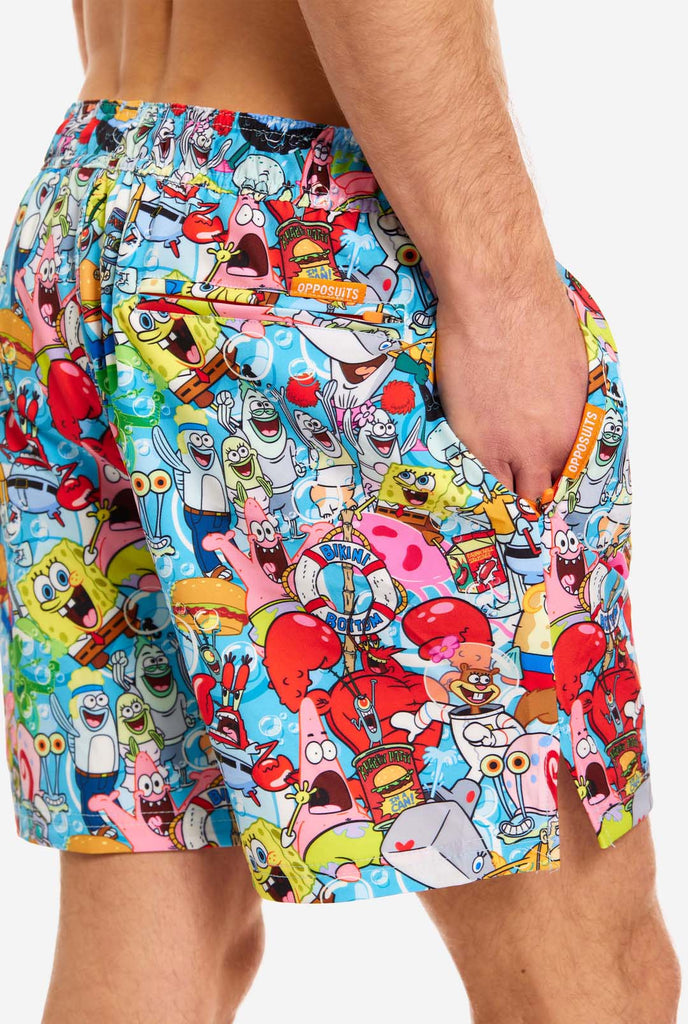 Man wearing swim trunks with SpongeBob print, close up