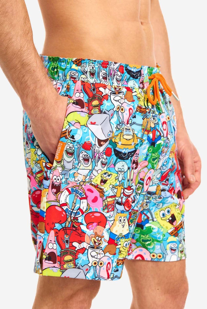 Man wearing swim trunks with SpongeBob print, close up