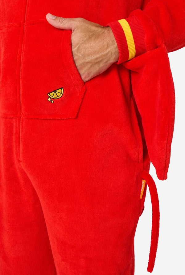 Ein Mann trägt einen leuchtend roten Onesie für Erwachsene mit Hummermotiv, verspielten Kapuzendetails und kuscheligem, weichem Material, perfekt zum Entspannen oder für Kostümveranstaltungen. Mit aufgenähten Handschuhen als Krallen. Nahaufnahme der Tasche.