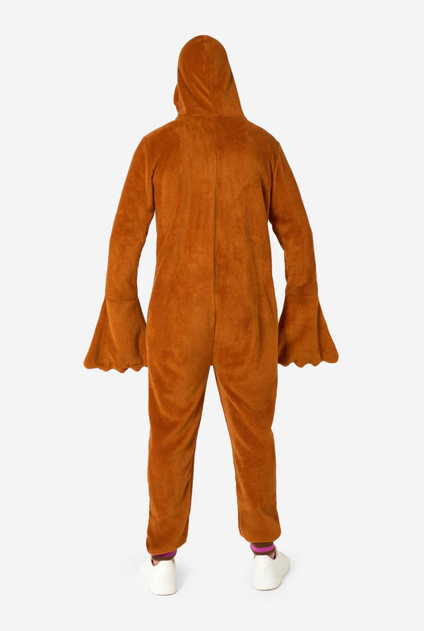 Ein fröhlicher Mann trägt einen braunen Erwachsenen-Onesie in Walross-Optik. Der Onesie hat eine Kapuze mit Reißzähnen, aufgenähte Handschuhe in Pfotenform und verspielte Walross-Details – perfekt für gemütliches Faulenzen oder Kostümpartys. Ganzkörperansicht von hinten.