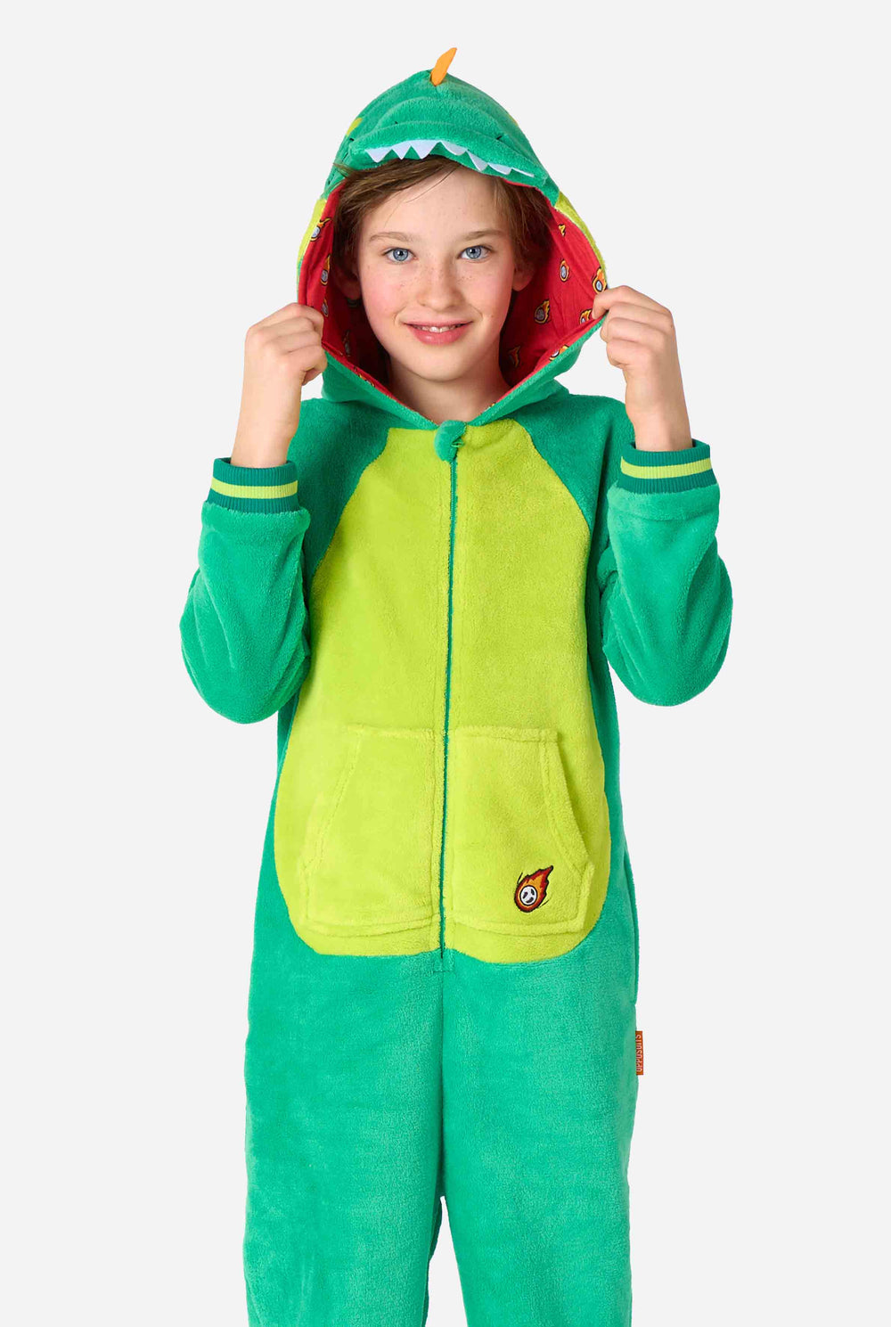 Ein Kind trägt einen grünen Dinosaurier-Onesie für Kinder mit verspielten Kapuzen-Details und gemütlichem, weichem Material – perfekt zum Entspannen oder für Kostümveranstaltungen.