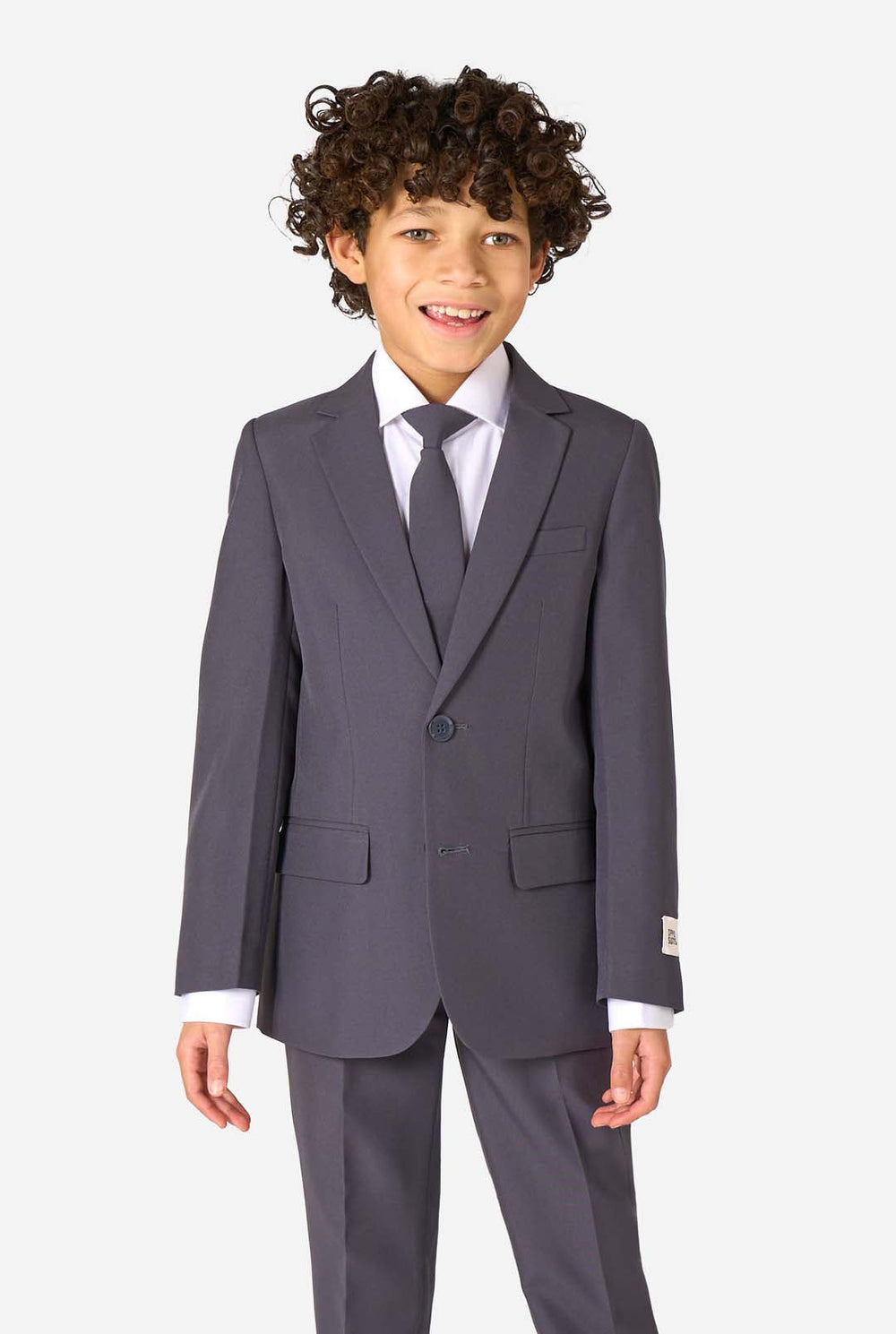 Junge in einem eleganten, anthrazitfarbenen Anzug mit weißem Hemd und selbstbewusstem Lächeln. Perfektes formelles Outfit für besondere Anlässe, Hochzeiten und Partys.