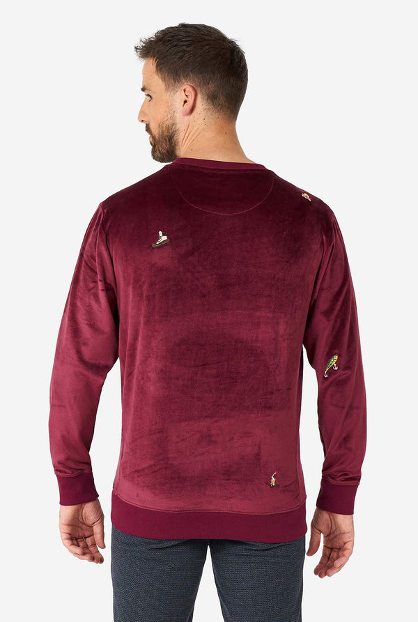 Mann, der Velvet Burgund rotes Weihnachtspullover mit Weihnachtsikonen trägt, Blick von hinten