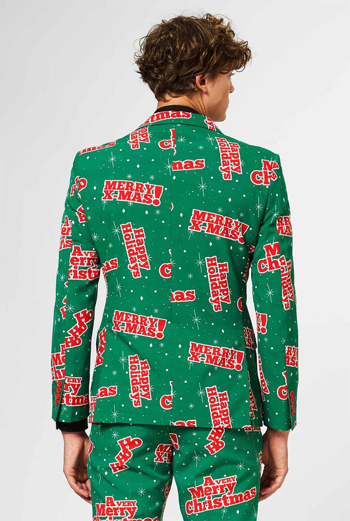 Mann, der einen grünen Weihnachtsanzug mit roten Weihnachtsphrasen trägt, Blick von hinten