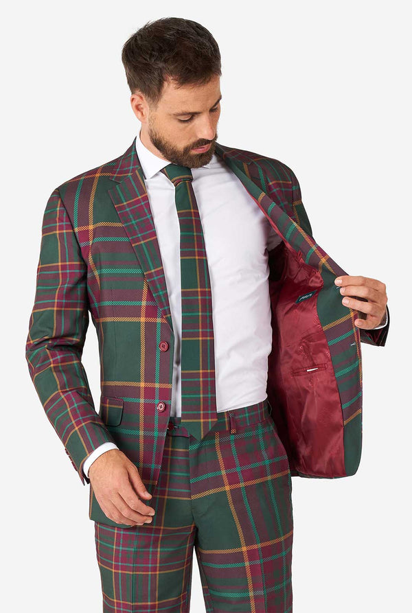 Mann, der einen tartanplaid -Weihnachtsanzug trägt, Jacke im Inneren anzeigen