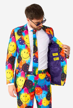 Mann, der einen farbenfrohen Männeranzug mit Smiley -Druck trägt, Blick im Innen