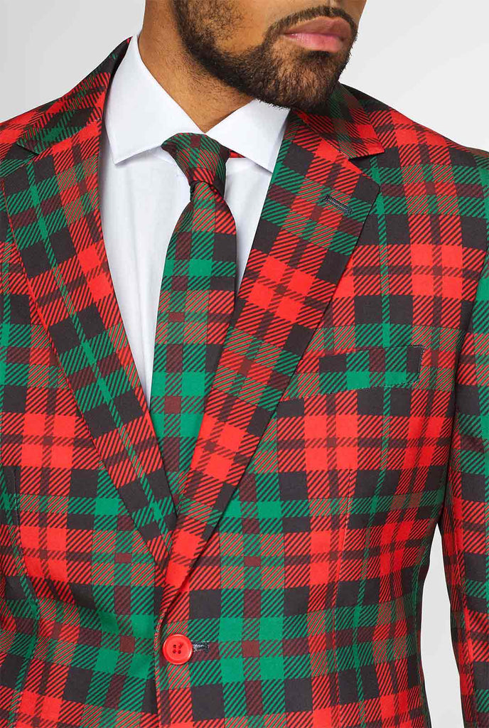 Grüne und rote Tartan -Weihnachtsanzug vom Mann getragen, Nahaufnahme Jacke und Krawatte