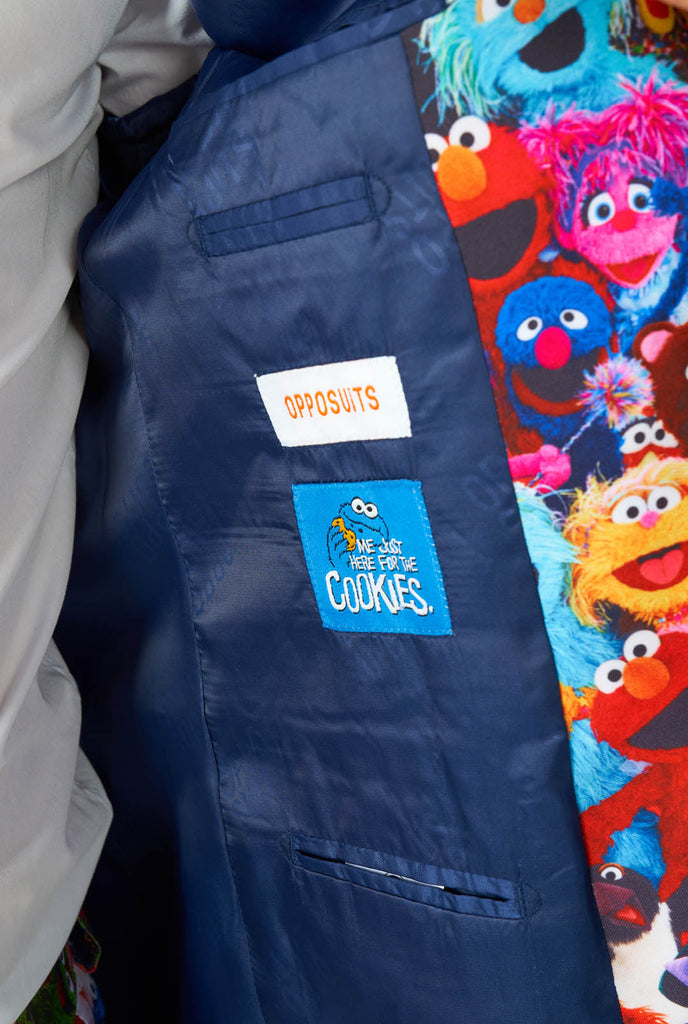 Man wearing men's suit with Sesame street characters print, inside jacket